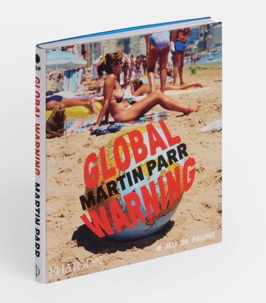 Colour cover with Parr image of people sunbathing on a beach, with an inflatable globe. On it the title in red letters and the name Martin Parr in black letters.