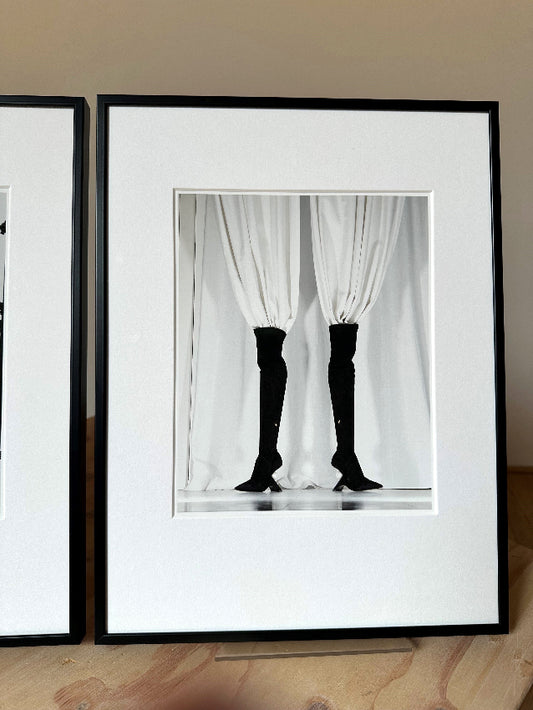 first edition print framed in a black frame standing on a wooden block
