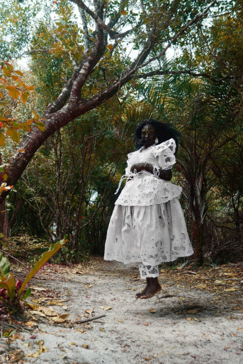 Jumping woman in a white lace dress