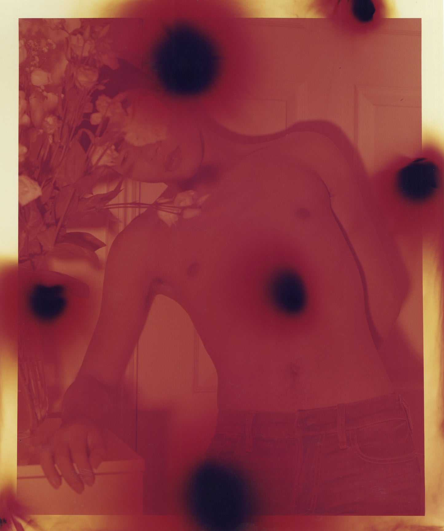 Red and yellow image of a figure, layered with black dots