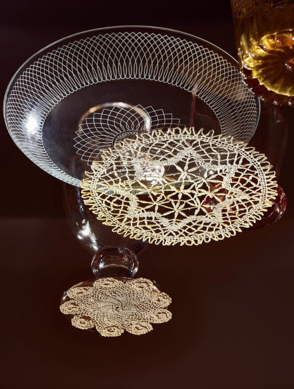 Doilies and glasswear on a black background
