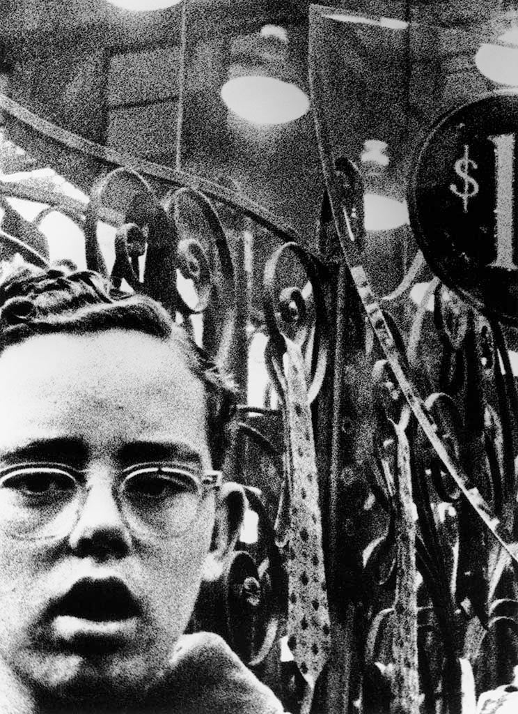 portrait of young boy with glasses on the street