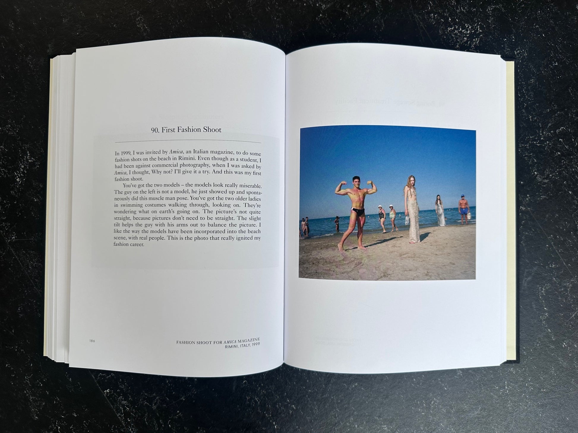 Spread with text on the left page and one colour photo on the right of people standing on a beach