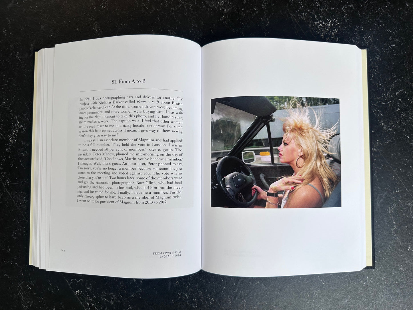 Spread with text on the left page and one colour photo on the right of a woman driving in a cabriolet.