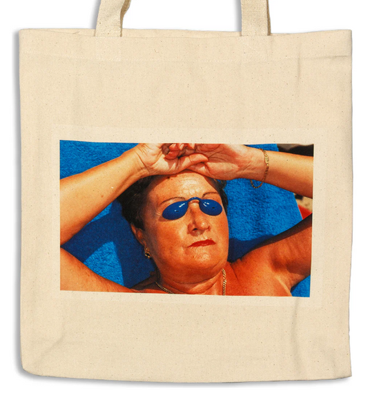 Ecru totebag with colour image of woman tanning with blue plastic glasses