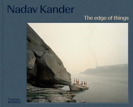 Blue linnen bookcover with The Edge of things in white letters and Nadav Kander and Thames & Hudson in blue letters. Bottom right a photo of the Yangtze series, with a group of swimmers standing on a rock in the river.