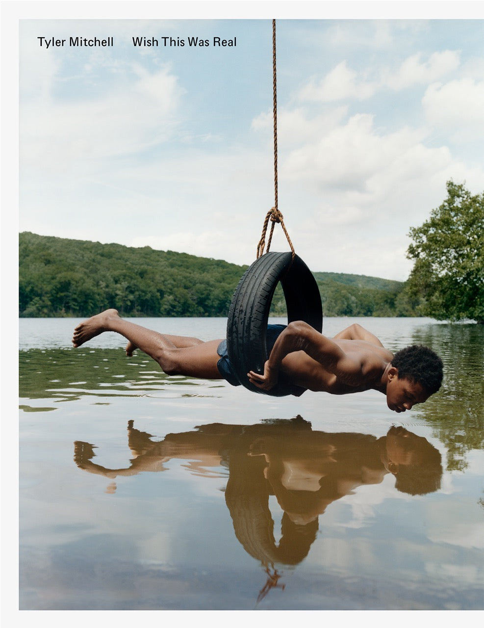 cover book with a man in a car tire hovering above a lake wearing swimming trunks