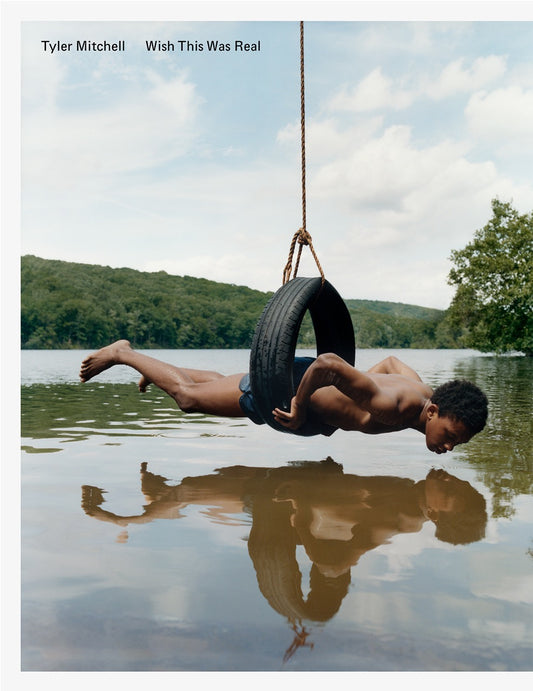 cover book with a man in a car tire hovering above a lake wearing swimming trunks