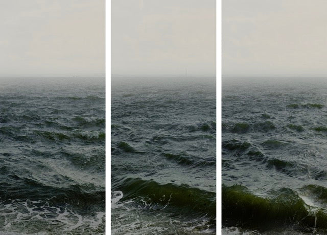 Triptych of three standing colour photos of  a wild sea with the horizon on 1/4 of the top.