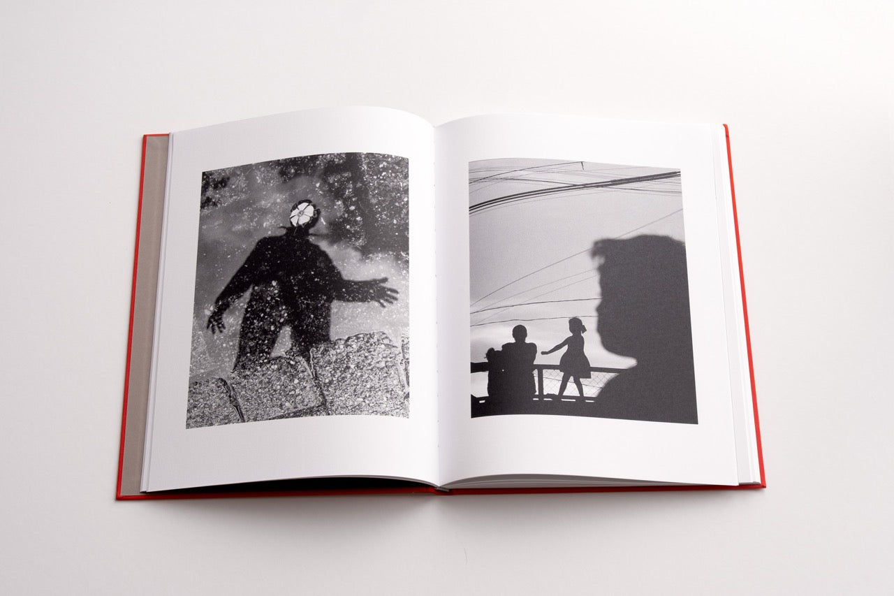 book spread with two black and white images of street views