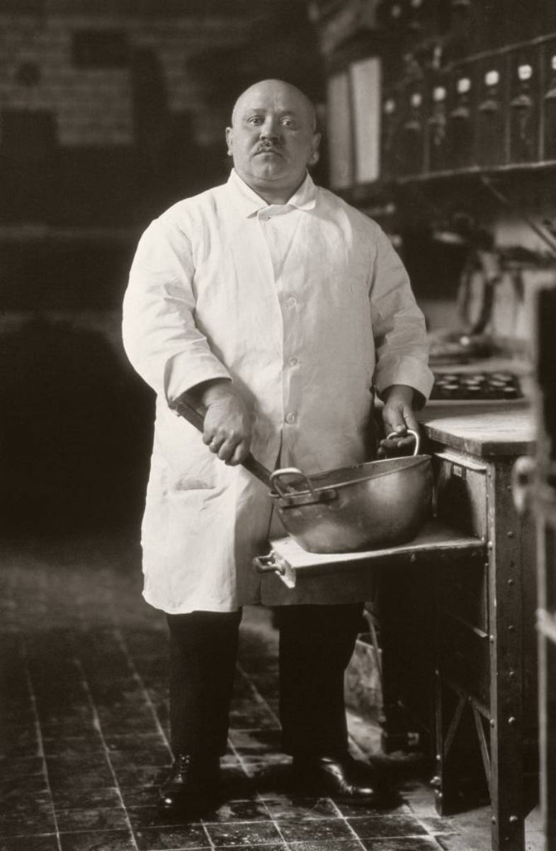 black and white portrait of a baker holding a pan