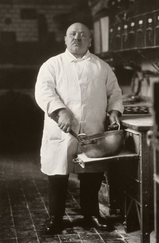 black and white portrait of a baker holding a pan