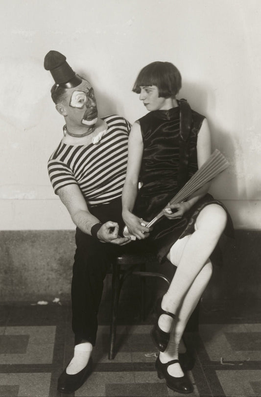 black and white portrait of clown and woman with fan