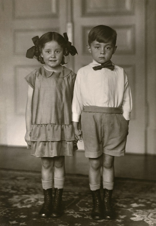 black and white portrait of little boy and girl holding hands