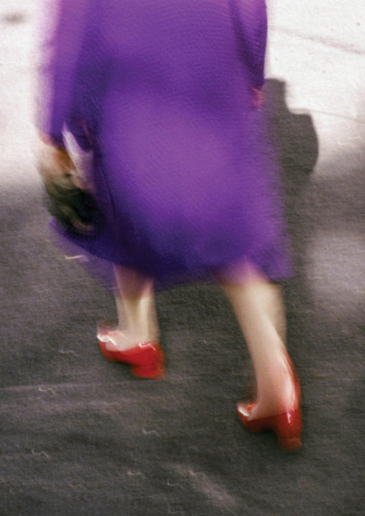 woman in purple coat with red heels