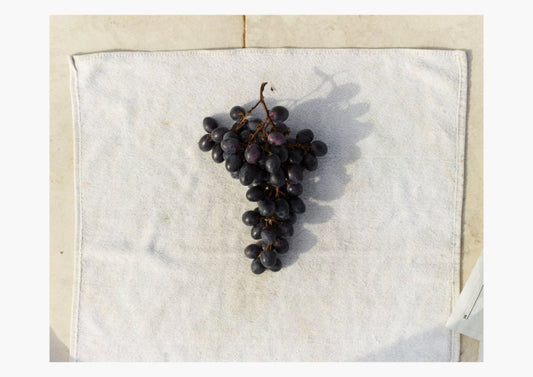 black grapes on a white towel
