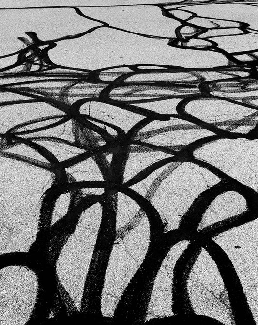 black tar against a grainy grey background