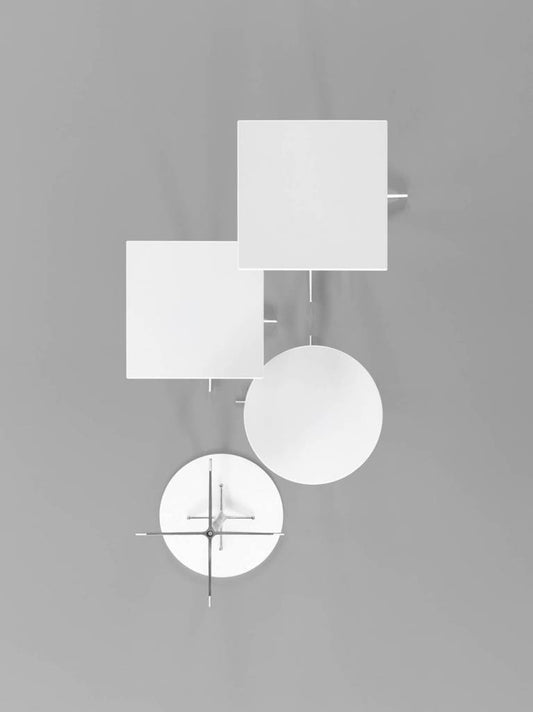 four white tables photographed from above against a grey background