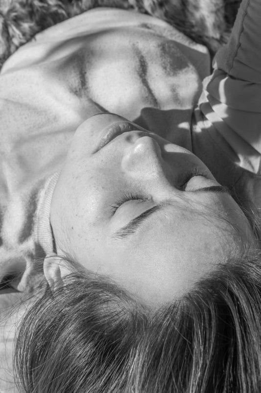 Black and white image of woman lying down