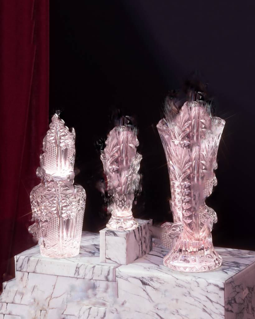 Three glass vases on a marble pedestal