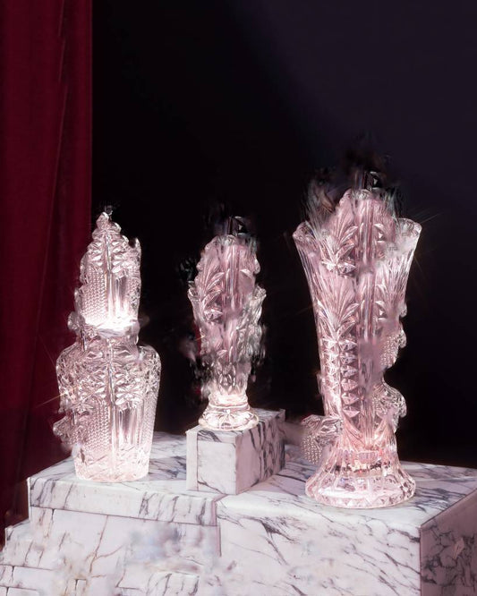 Three glass vases on a marble pedestal
