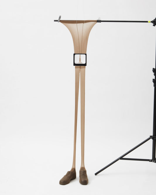 a stretched out nude panty, worn over a set of shoes