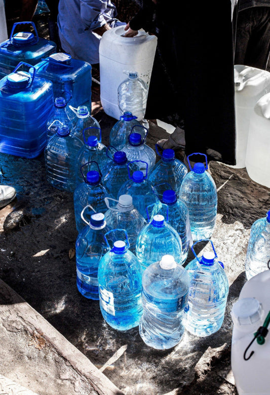 Blue waterbottles on a stone road